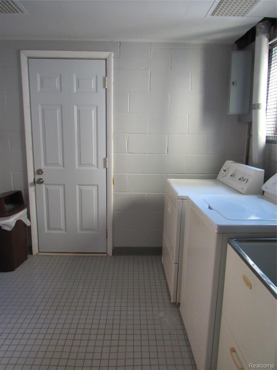 5740 Textile Road Ypsilanti, MI 48197 - Photo 17 of 62 Laundry offers Tiled flooring and a service door that leads to the large yard