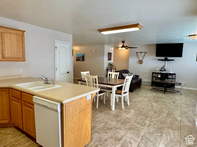 445 Topaz Boulevard, Unit 10 Delta, UT 84624 - Photo 27 of 28 Kitchen with dishwasher, a sink, light countertops, open floor plan, and a textured ceiling