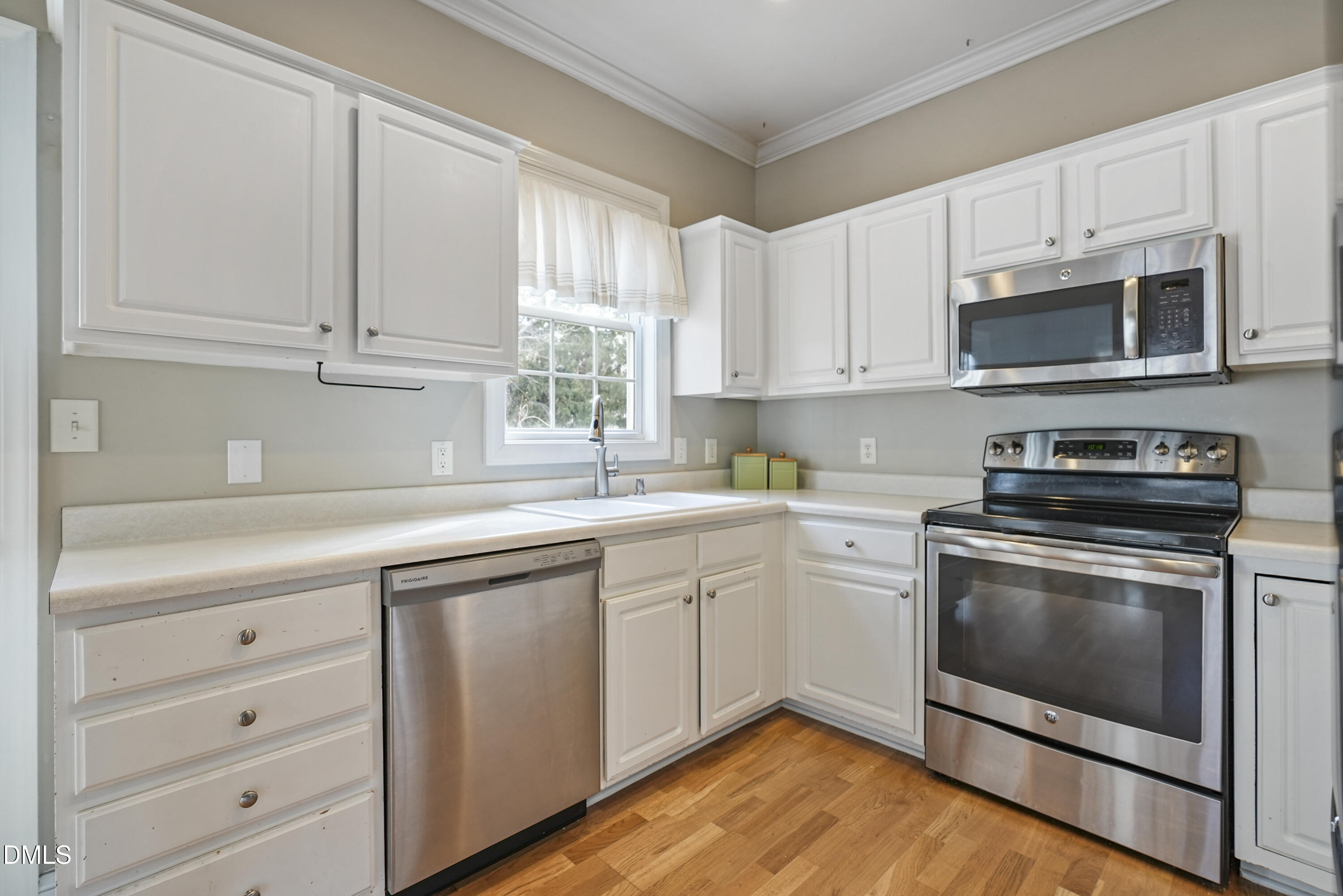 4912 Morning Edge Drive Raleigh, NC 27613 - Photo 15 of 35 a kitchen with cabinets stainless steel appliances a sink and a window