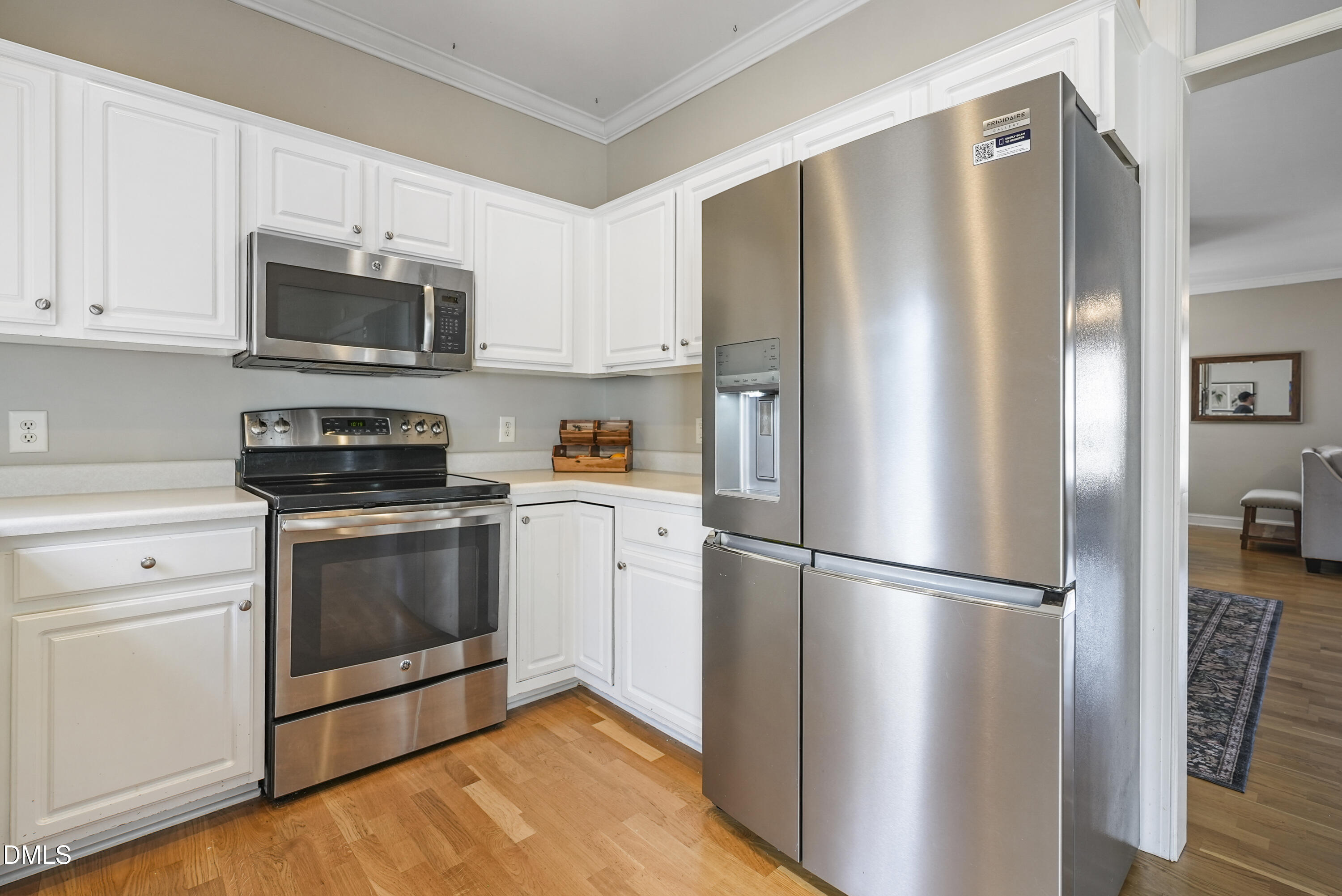 4912 Morning Edge Drive Raleigh, NC 27613 - Photo 16 of 35 a kitchen with stainless steel appliances a refrigerator microwave and sink