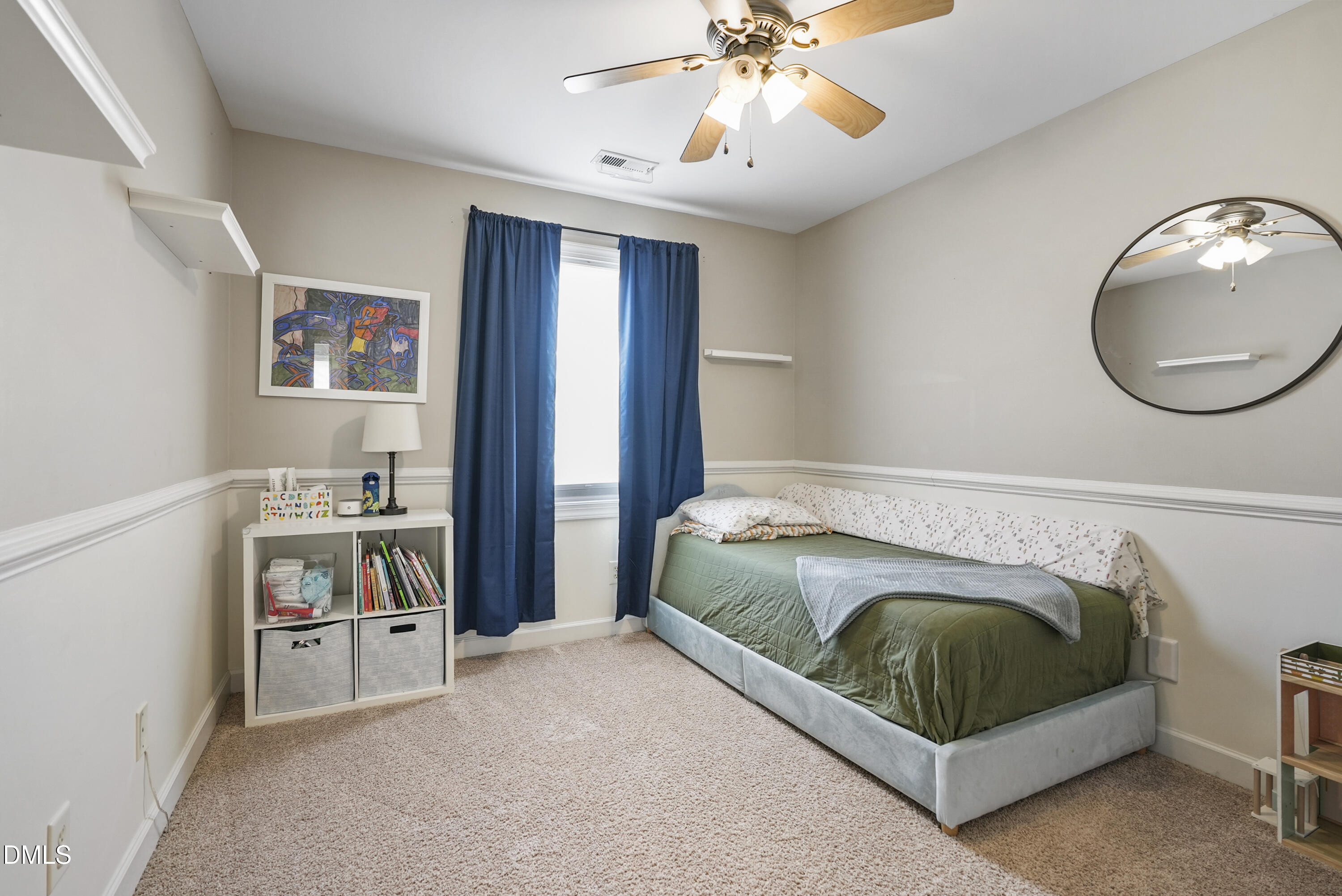 4912 Morning Edge Drive Raleigh, NC 27613 - Photo 21 of 35 a bedroom with a bed and a chandelier