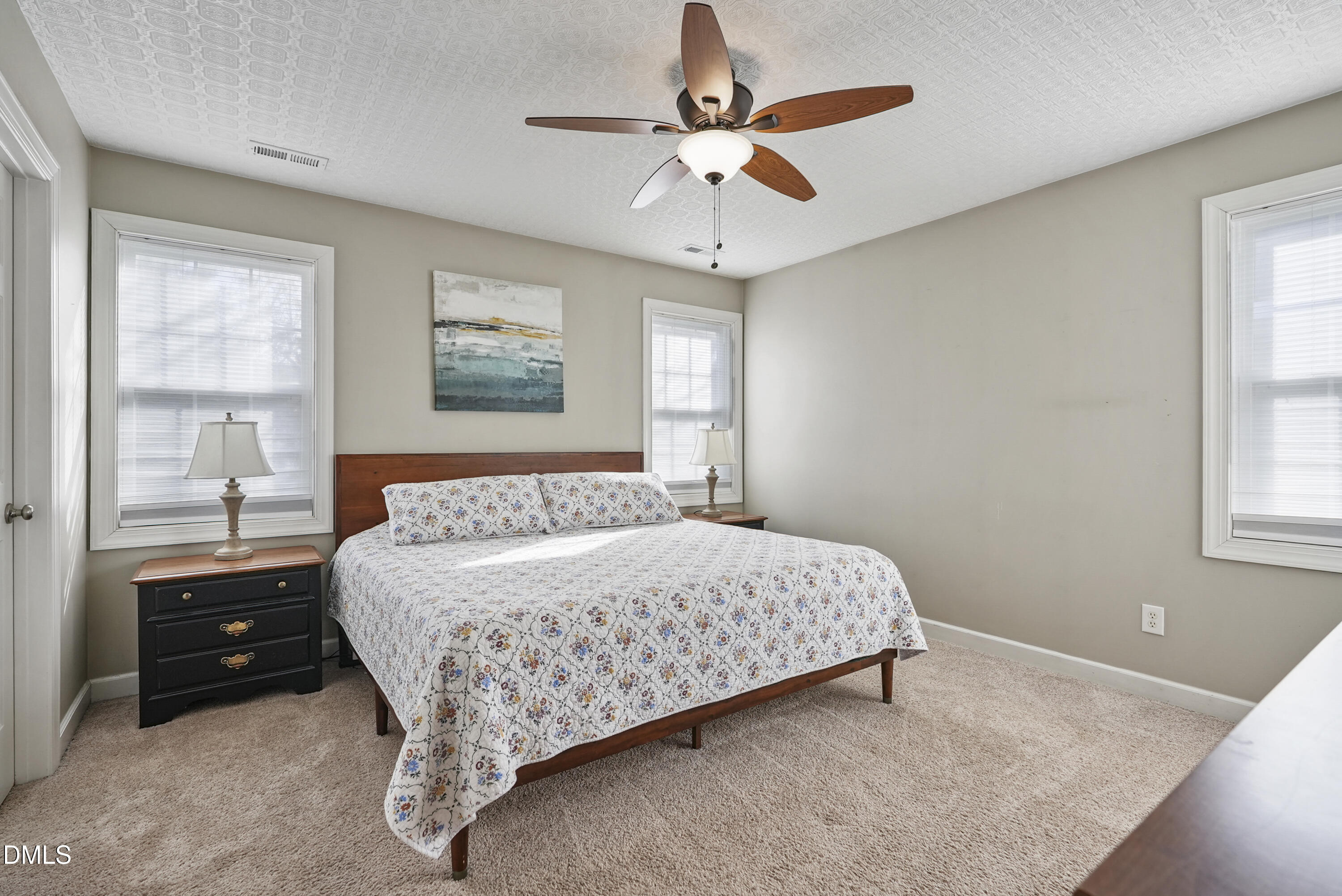 4912 Morning Edge Drive Raleigh, NC 27613 - Photo 24 of 35 a bedroom with a bed and a window