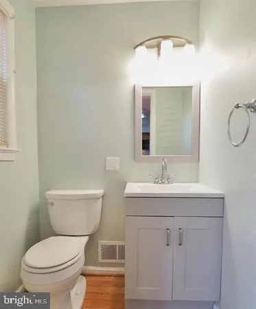 a bathroom with a toilet a sink and mirror