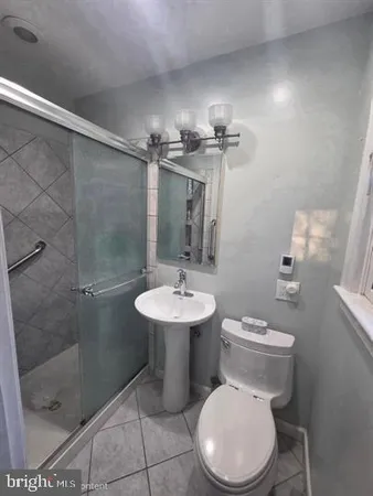 a bathroom with a toilet sink and shower