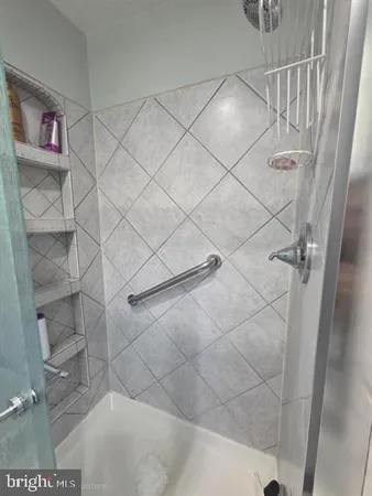 a bathroom with a shower and a glass door shower