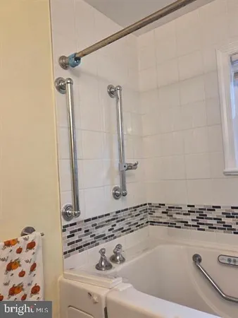 a bathroom with a bathtub and shower