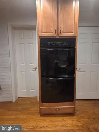 a stove top oven sitting inside of a kitchen