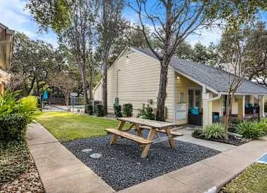 a house view with a sitting space and garden