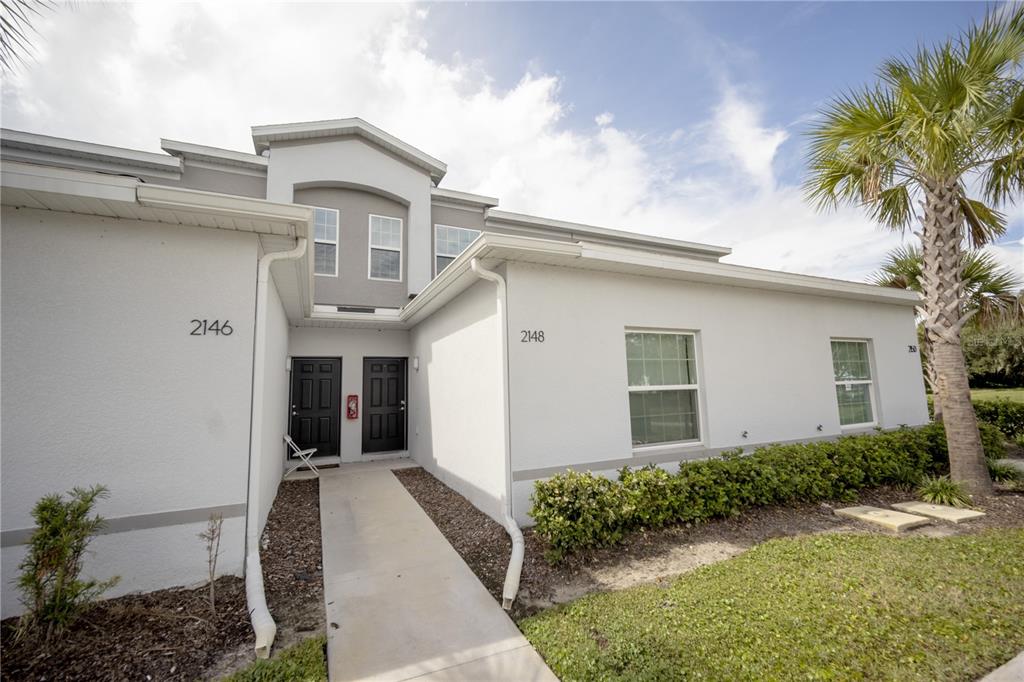 2148 Penny Lane Kissimmee, FL 34741 - Photo 2 of 15 a front view of a house with a yard
