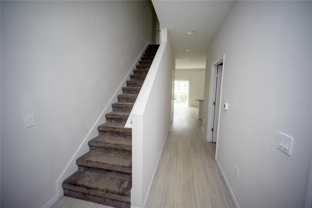 2148 Penny Lane Kissimmee, FL 34741 - Photo 3 of 15 a view of a hallway with wooden floor and entryway