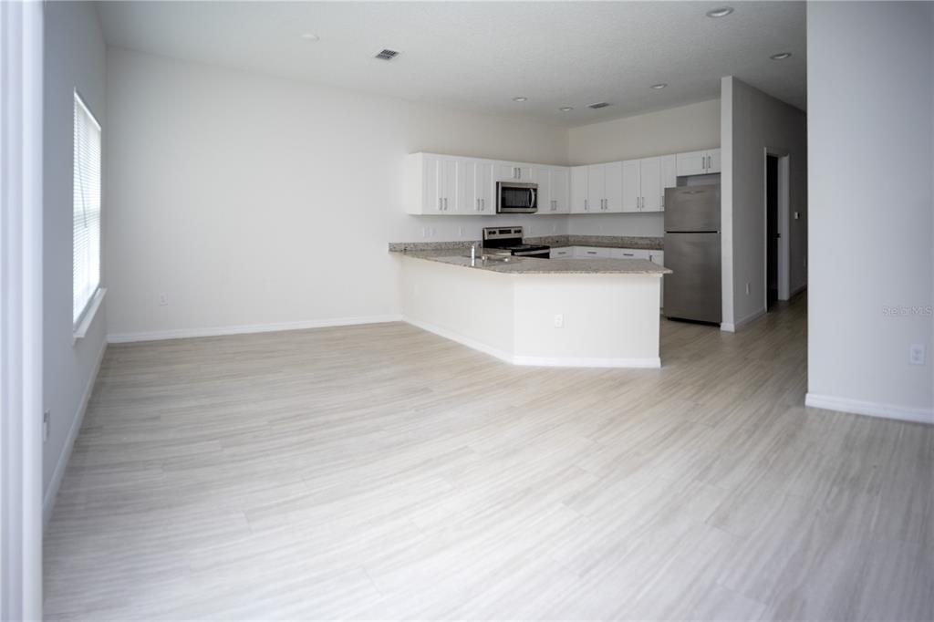 2148 Penny Lane Kissimmee, FL 34741 - Photo 6 of 15 a view of kitchen with stainless steel appliances refrigerator oven and cabinets