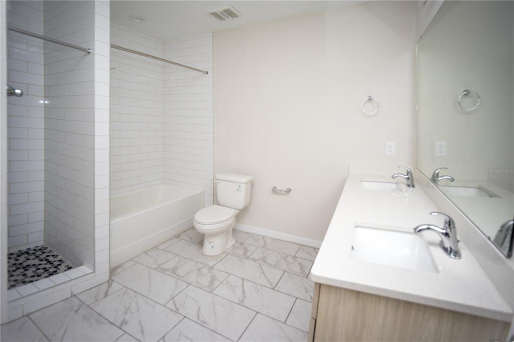 2148 Penny Lane Kissimmee, FL 34741 - Photo 9 of 15 a bathroom with a sink toilet and shower