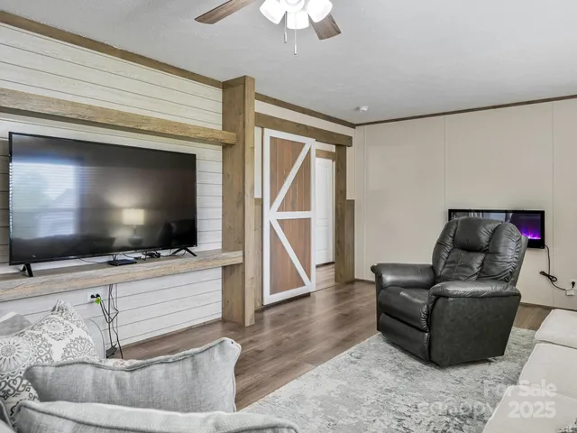 a living room with furniture and a flat screen tv