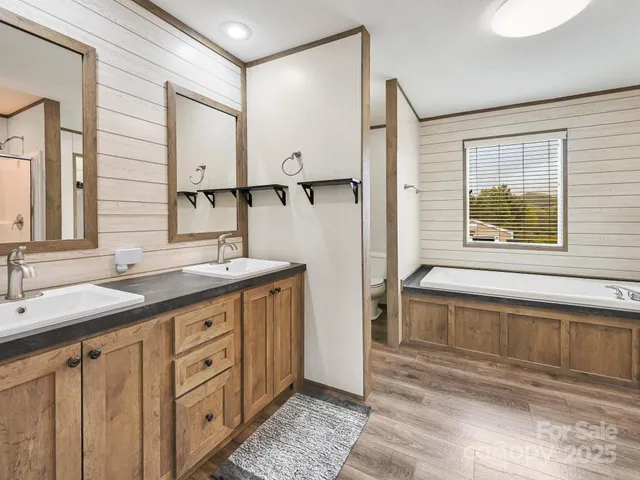 a bathroom with a double vanity sink and a mirror