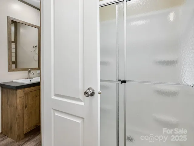 a bathroom with a shower and a sink