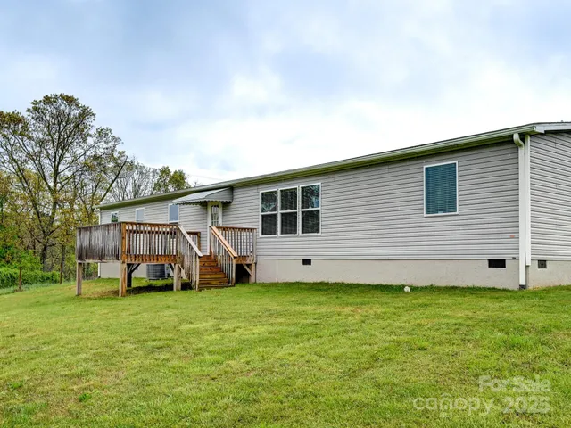 a view of a house with a yard and porch