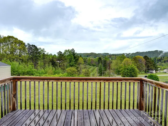 a balcony with wooden floor and fence
