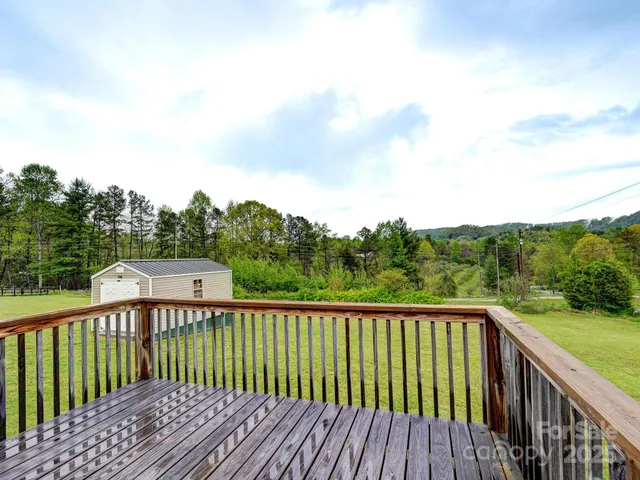 a balcony with wooden floor and fence