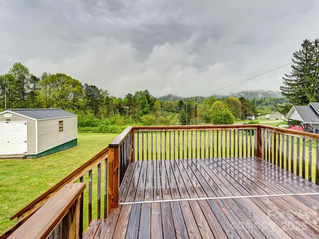 a balcony with wooden floor and fence