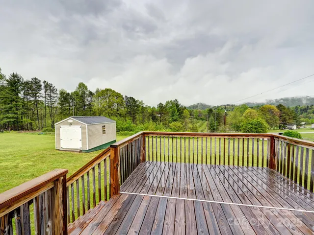 a balcony with wooden floor and fence