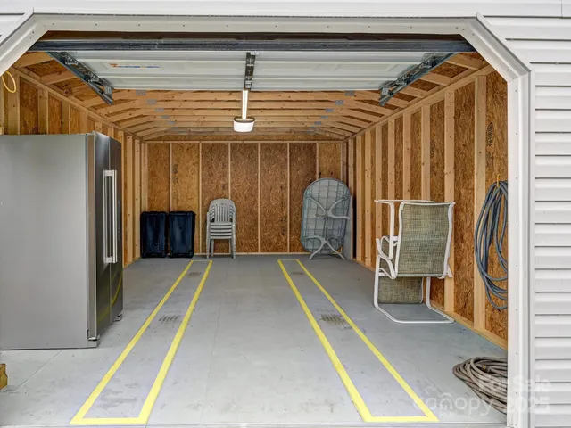 a view of an empty room with a window and a bath tub