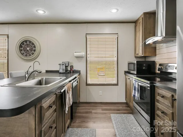 a kitchen with a sink and a stove top oven