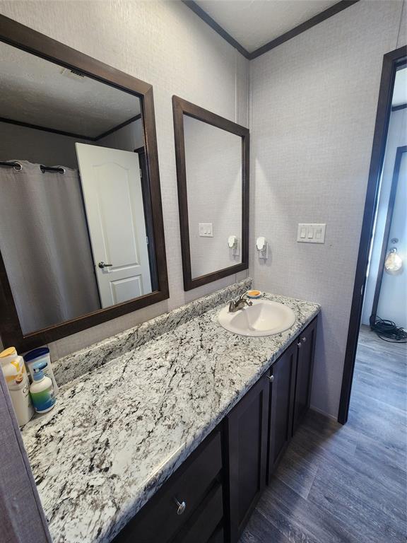 191 Sioux Quitman, TX 75783 - Photo 13 of 23 a bathroom with a granite countertop sink and a mirror