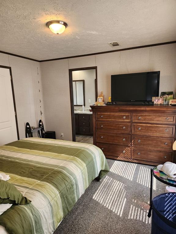 191 Sioux Quitman, TX 75783 - Photo 14 of 23 a bedroom with a bed and a flat screen tv
