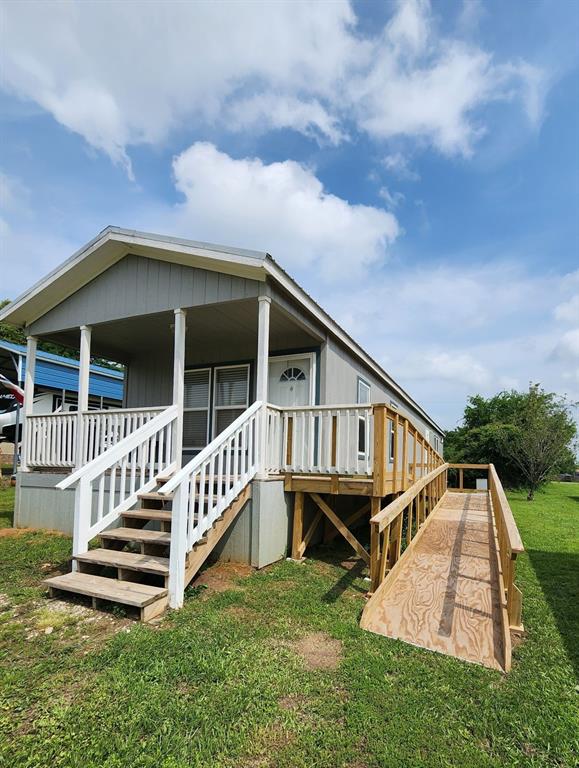 191 Sioux Quitman, TX 75783 - Photo 3 of 23 a view of house with a yard and deck