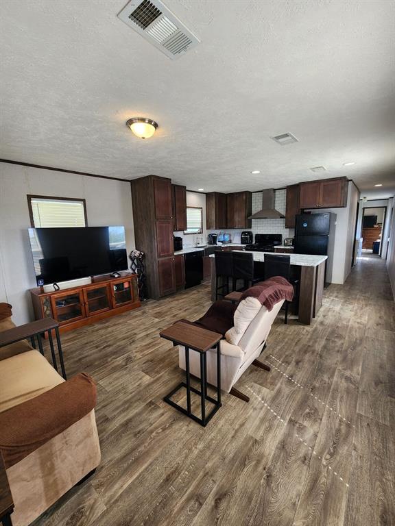 191 Sioux Quitman, TX 75783 - Photo 5 of 23 a living room with furniture a flat screen tv and kitchen view