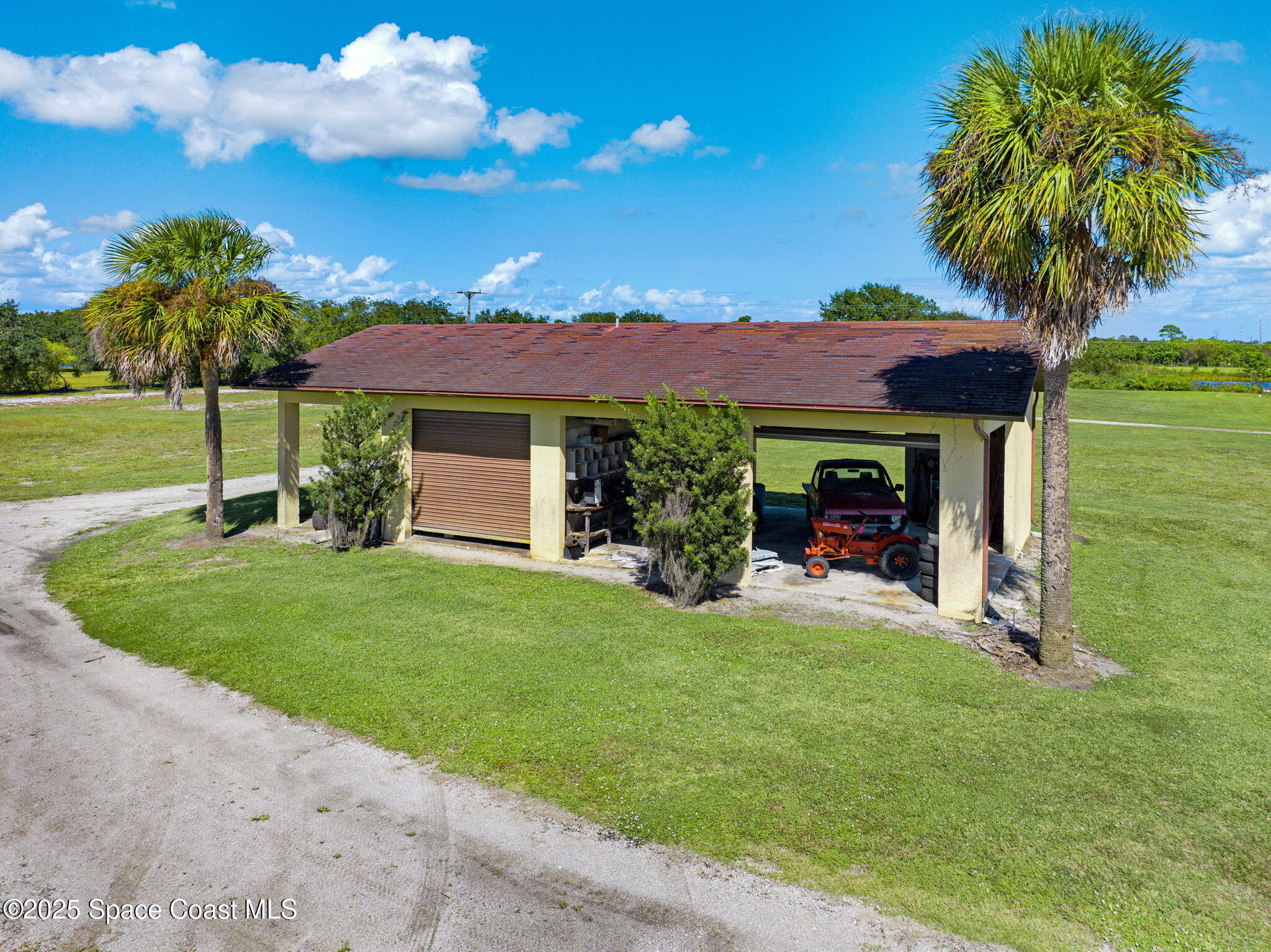 B Berry Road Grant Valkaria, FL 32949 - Photo 45 of 46 a view of a house with a yard and potted plants