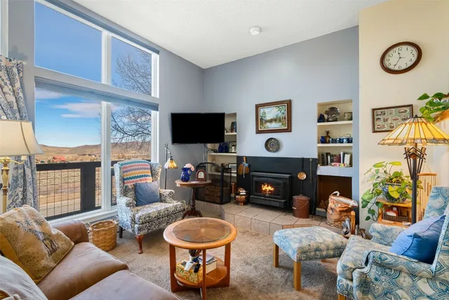 a living room with furniture a rug and a flat screen tv