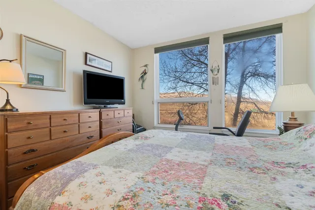 a bed room with a bed and a flat screen tv