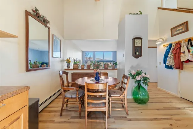 a dining room with furniture and wooden floor
