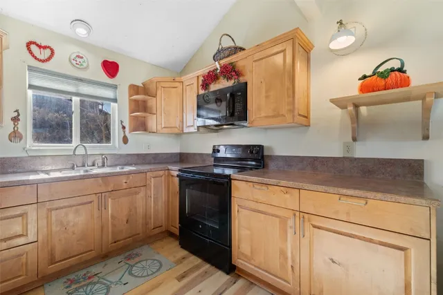 a kitchen with stainless steel appliances granite countertop a sink and a stove