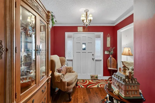 a view of a dining room with furniture and chandelier