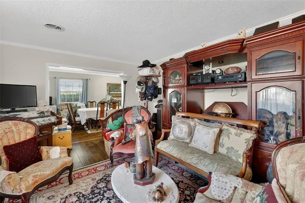 a living room with furniture ceiling fan and a large window