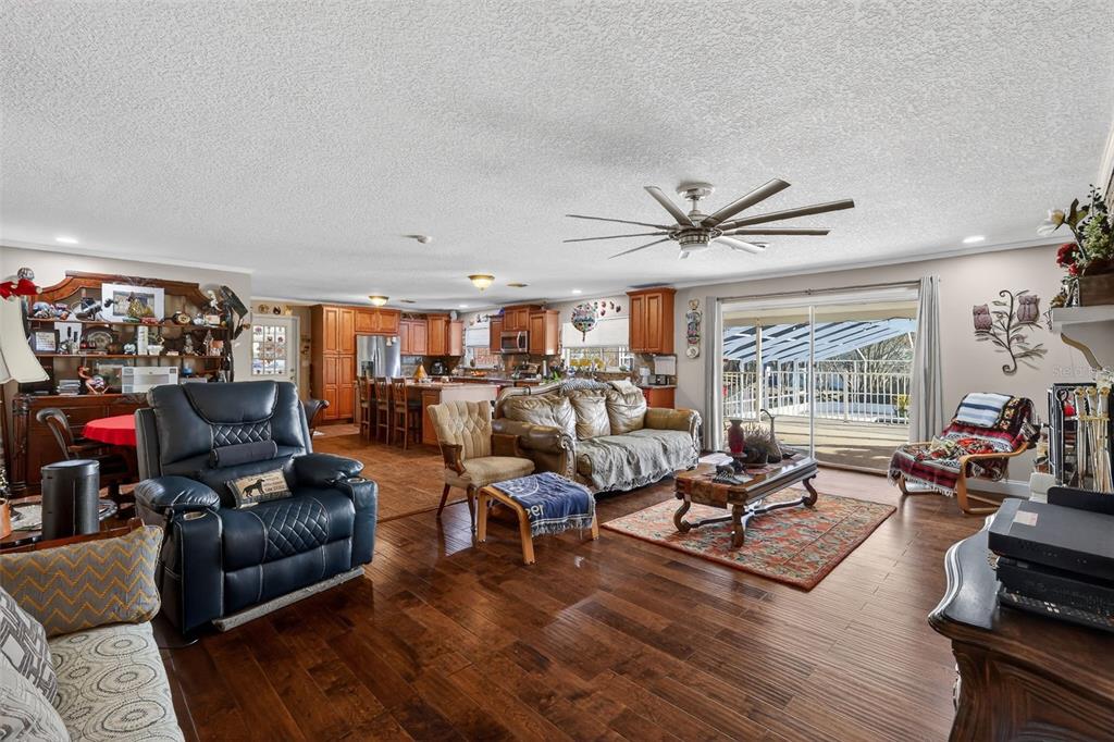 2230 Southwest 87th Place Ocala, FL 34476 - Photo 14 of 42 a living room with furniture ceiling fan and a large window