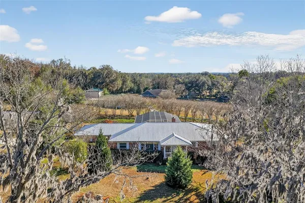 a view of a house with a yard and mountains