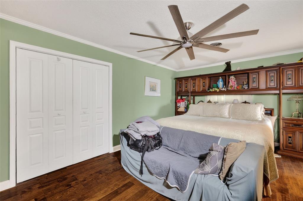 2230 Southwest 87th Place Ocala, FL 34476 - Photo 25 of 42 a bedroom with a bed and wooden floor