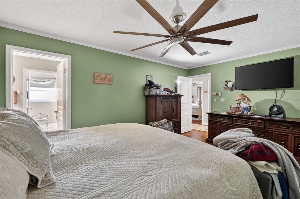 2230 Southwest 87th Place Ocala, FL 34476 - Photo 26 of 42 a bedroom with a bed and a flat screen tv