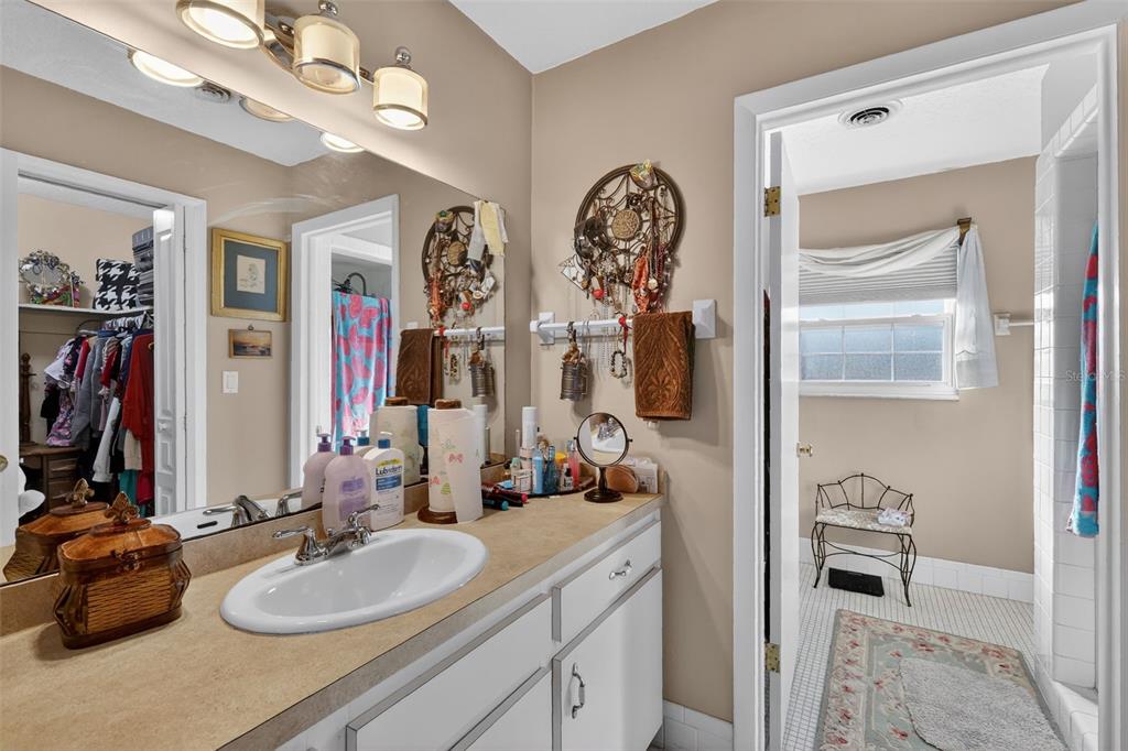 2230 Southwest 87th Place Ocala, FL 34476 - Photo 27 of 42 a bathroom with a double vanity sink and a mirror