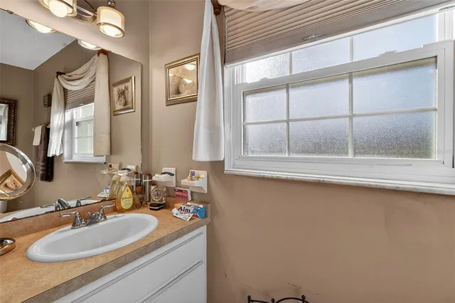 a bathroom with a sink double vanity and a toilet