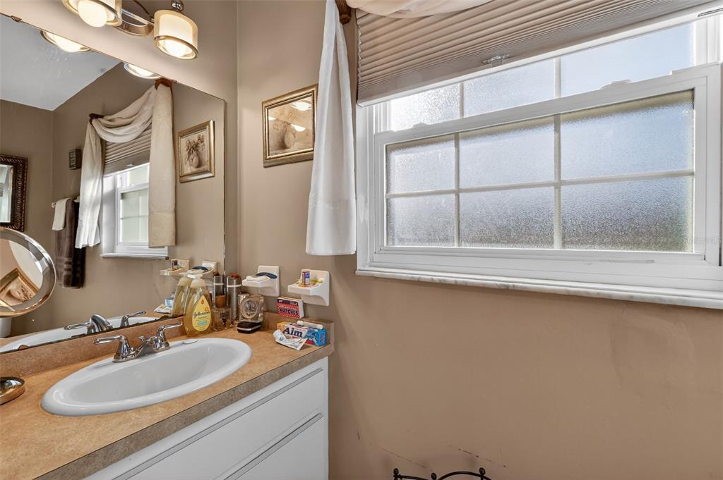2230 Southwest 87th Place Ocala, FL 34476 - Photo 28 of 42 a bathroom with a sink and a mirror