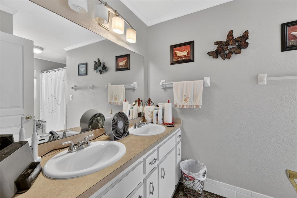 2230 Southwest 87th Place Ocala, FL 34476 - Photo 30 of 42 a bathroom with a sink double vanity and a toilet