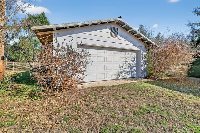 a front view of a house with a yard and a garage