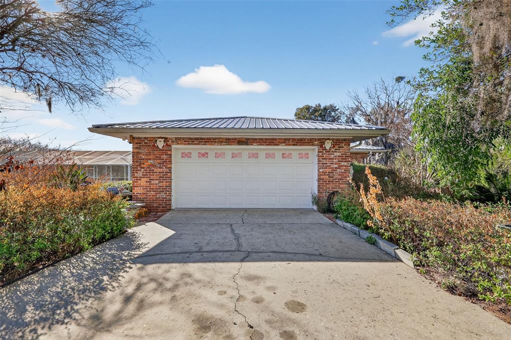 2230 Southwest 87th Place Ocala, FL 34476 - Photo 40 of 42 a view of a house with a yard and potted plants