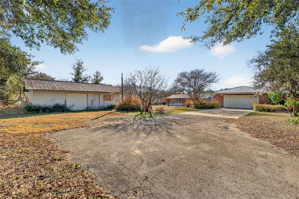 2230 Southwest 87th Place Ocala, FL 34476 - Photo 41 of 42 a front view of a house with a yard and a garage