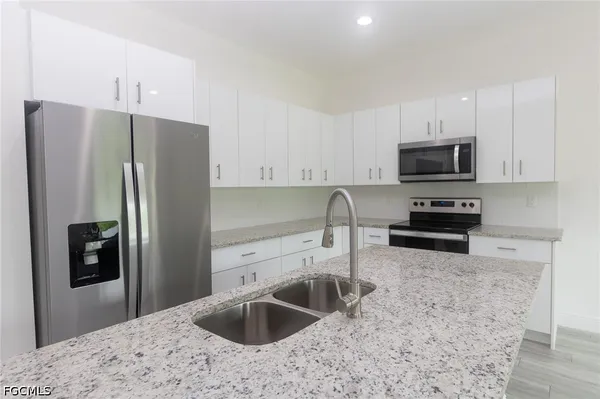 a kitchen with a refrigerator sink and microwave