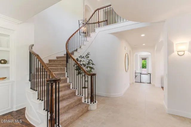 a dining room with wooden floor a chandelier a wooden table and chairs